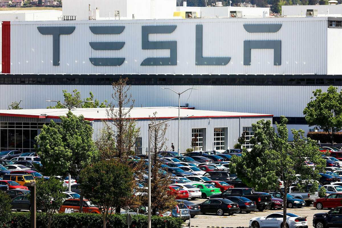 A person enters a building at the Tesla car factory on Monday, May 11, 2020 in Fremont, California. Tesla has reopened its Fremont car factory in defiance of county rules prohibiting car manufacturing during shelter-in-place.