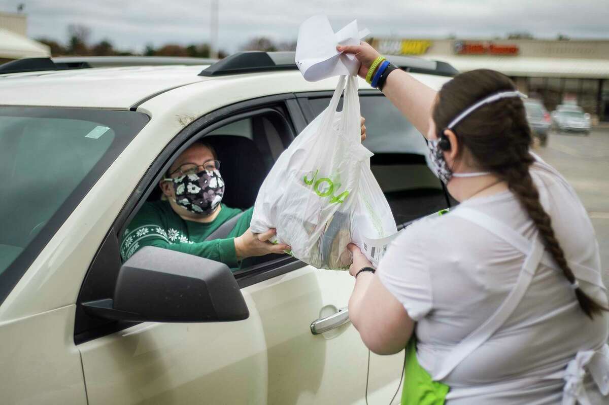 JoAnn Fabrics and Crafts employee Caitlin Hill, right, brings an order out to customer Kayla Schlicker, left, Monday at the store in Midland. (Katy Kildee/kkildee@mdn.net)