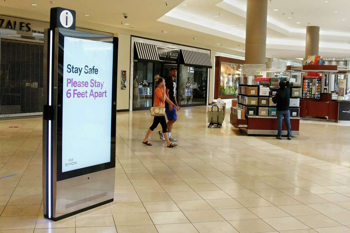 Signage encourages social distancing as Penn Square Mall reopens to the public Friday, May 1, 2020, in Oklahoma City. The mall has been closed since mid-March due to coronavirus concerns. (AP Photo/Sue Ogrocki)