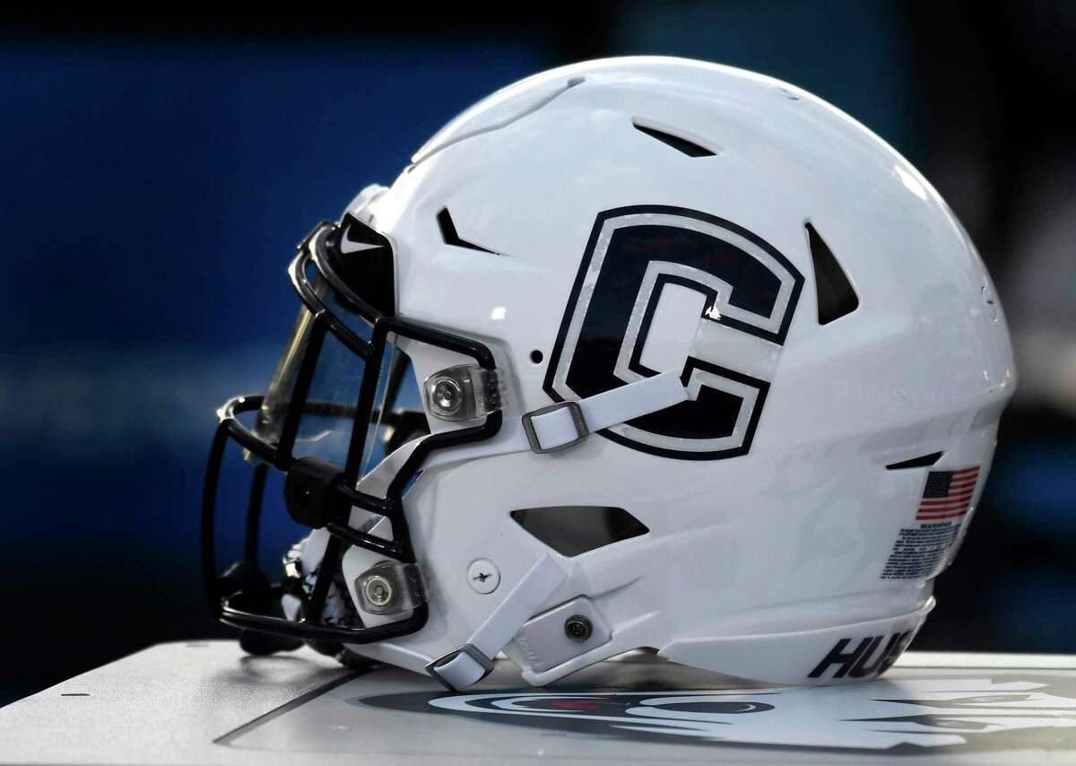 A Connecticut football helmet is seen on the sideline during an NCAA college football game, Saturday, Sept. 7, 2019, in East Hartford, Conn. (AP Photo/Jessica Hill)