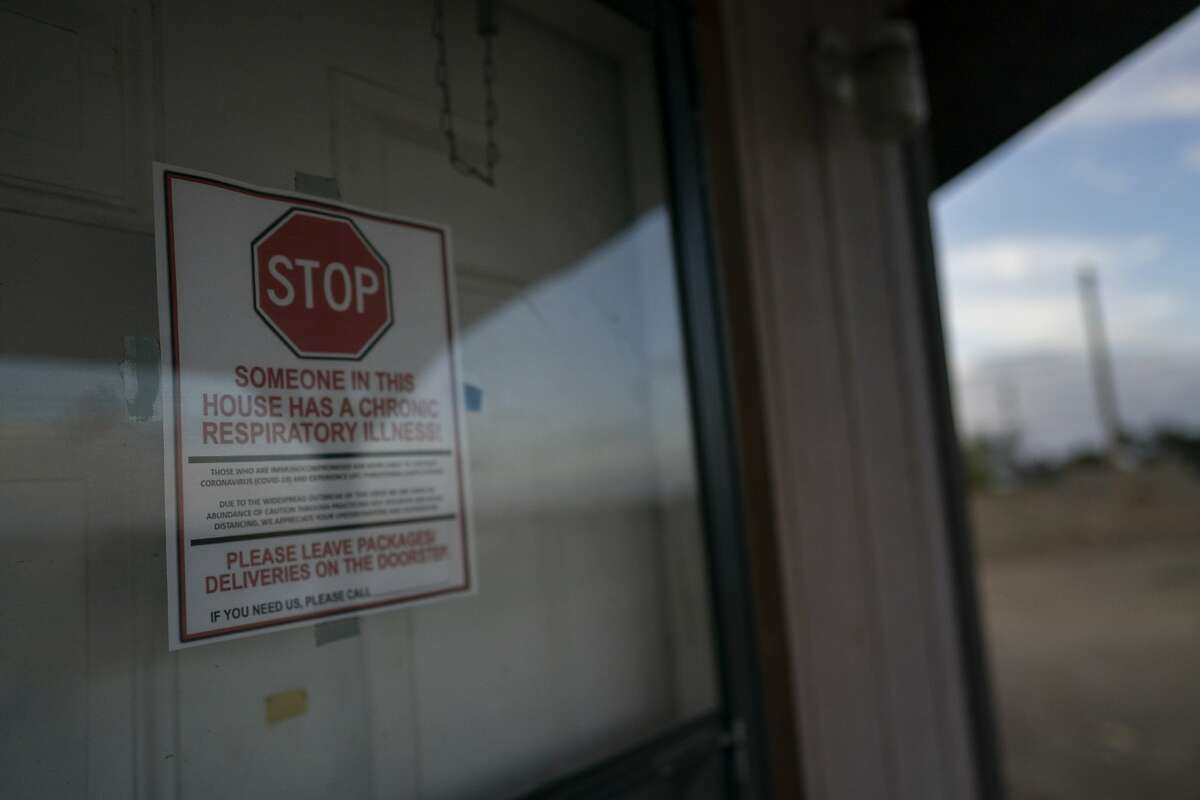 A sign is posted on the door of the hogan, a traditional Navajo dwelling, of Mabel Charley's home-bound uncle, to keep visitors out in Chilchinbeto, Ariz., on the Navajo reservation on April 21, 2020. The reservation has some of the highest rates of coronavirus in the country. If Navajos are susceptible to the virus' spread in part because they are so closely knit, that's also how many believe they will beat it. (AP Photo/Carolyn Kaster)