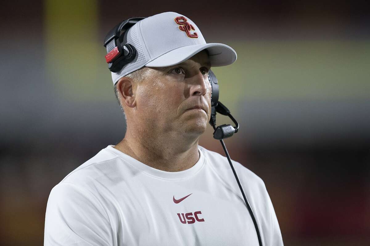 FILE - In this Sept. 31, 2019, file photo, Southern California head coach Clay Helton watches an NCAA college football game against Fresno State in Los Angeles. The Pac-12 has discussed the possibility of moving to an 11-game, all-conference schedule this year amid the unprecedented uncertainty of the coronavirus pandemic, Helton says. Stanford's David Shaw also says he does not necessarily agree with NCAA President Mark Emmert's belief that college campuses should be open for college sports to resume. (AP Photo/Kyusung Gong, File)