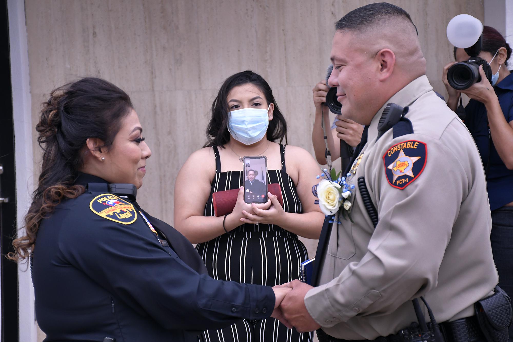 Laredo officers marry in uniform, with judge presiding via teleconference