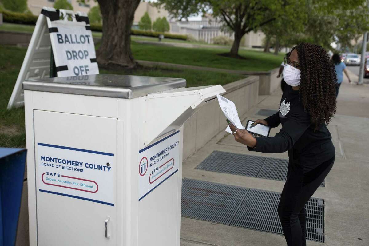 An Ohio voter drops off her ballot at the Board of Elections in Dayton, Ohio on April 28, 2020. - On March 17, 2020 Governor Mike DeWine and Ohio Department of Health Director Amy Acton delayed Ohio primaries over coronavirus concerns. The primaries were changed exclusively to a vote-by-mail system to reduce chances of virus spread. (Photo by Megan JELINGER / AFP) (Photo by MEGAN JELINGER/AFP via Getty Images)