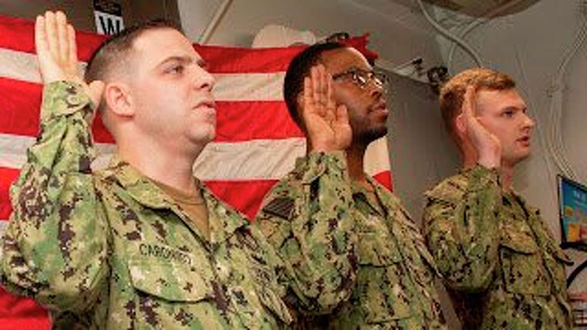 (Far right) Petty Officer 2nd Class Zachary Borst reenlisted in the U.S. Navy during a ceremony held onboard USS James E. Williams. Borst is a 2015 graduate of Reed City High School. (Submitted photo)