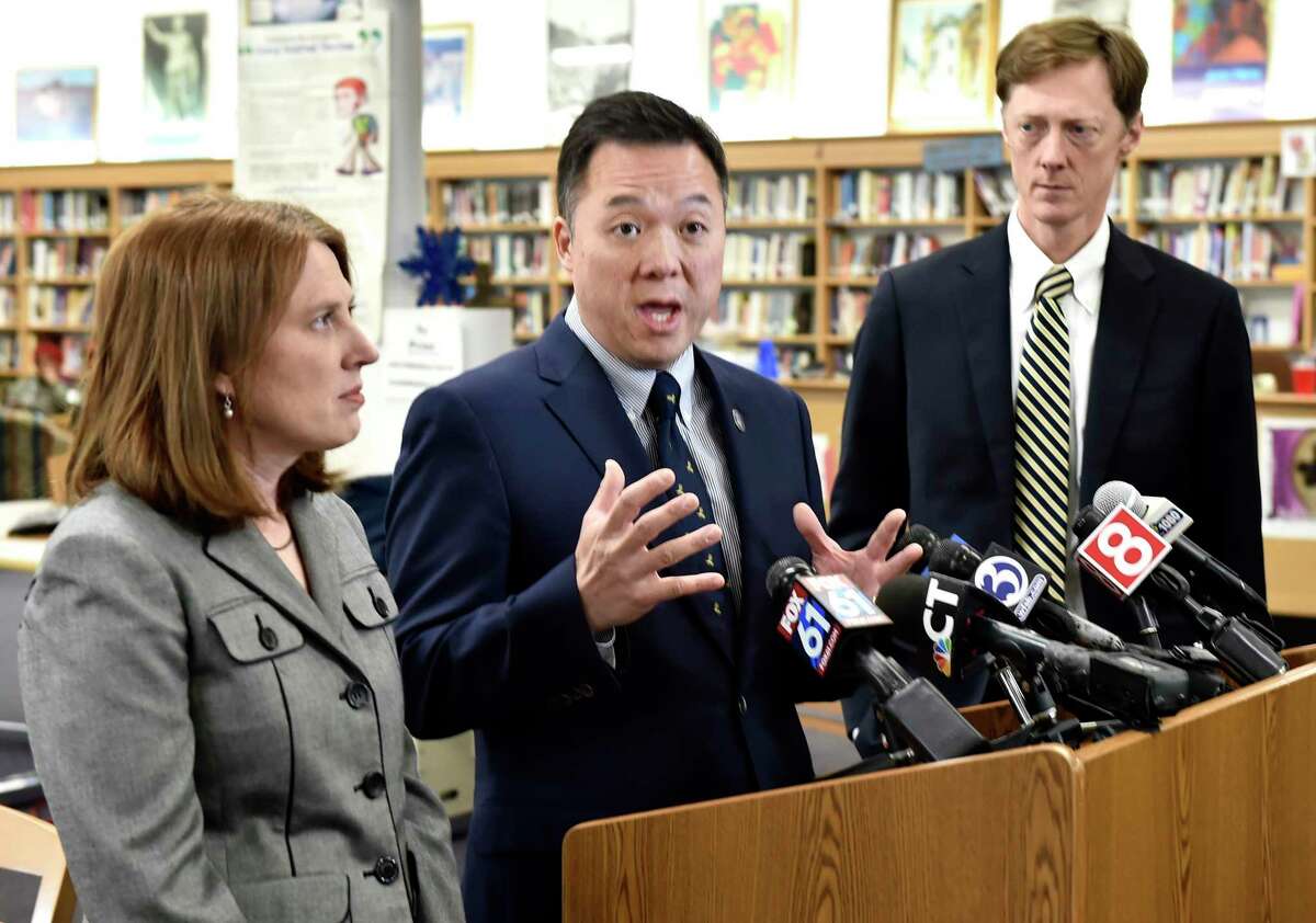 Connecticut Attorney General William Tong, center, New Haven Mayor Justin Elicker, right, and Connecticut Consumer Protection Commissioner Michelle Seagull, left, speak at Hillhouse High School in New Haven, Conn. Tong and Seagull announced March 24, 2021 that Connecticut would receive about $1.8 million through a 47-state settlement with medical-device manufacturer Boston Scientific.