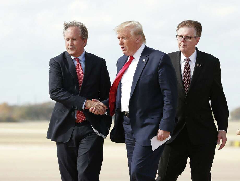 Donald Trump greets Texas Attorney General Ken Paxton (left) as Lt. Gov. Dan Patrick follows at Austin Bergstrom International Airport in  2019. Paxton recently blasted several coronavirus restrictions in San Antonio and Bexar County as “unlawful and unconstitutional.” Photo: Austin American-Statesman