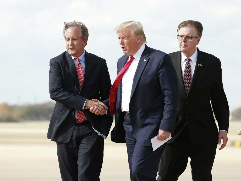 Donald Trump greets Texas Attorney General Ken Paxton (left) as Lt. Gov. Dan Patrick follows at Austin Bergstrom International Airport in  2019. Paxton recently blasted several coronavirus restrictions in San Antonio and Bexar County as “unlawful and unconstitutional.” Photo: JAY JANNER /AUSTIN AMERICAN-STATESMAN]