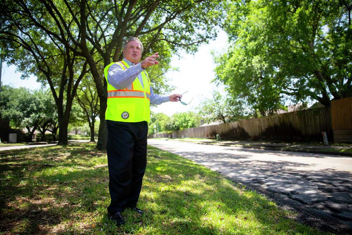 Houston District G Councilman Greg Travis surveys road damage along the median on Kirkwood on May 11, 2020. A long-delayed project will rebuild the street and drainage, but preserve most of the street’s trees.