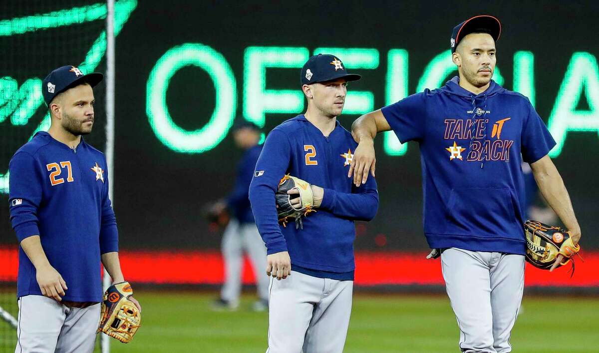 In their proposal for an 82-game season in 2020, MLB owners want players such as Astros second baseman Jose Altuve, from left, third baseman Alex Bregman and outfielder George Springer to accept a salary system that incorporates revenue sharing.