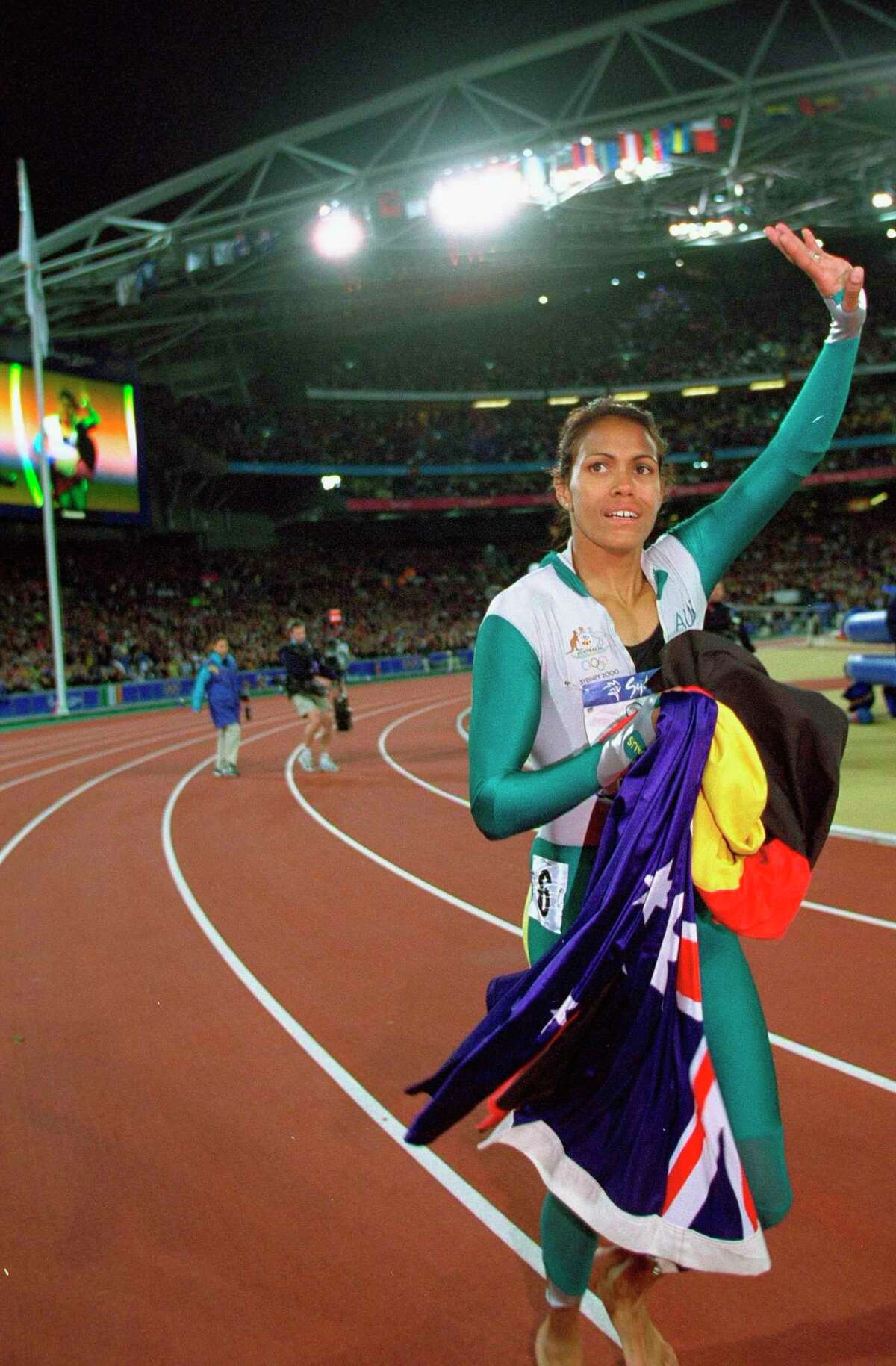 25 Sep 2000: Cathy Freeman of Australia celebrates winning Gold in the Womens 400m Final at the Olympic Stadium on Day Ten of the Sydney 2000 Olympic Games in Sydney, Australia. Mandatory Credit: Mike Powell /Allsport