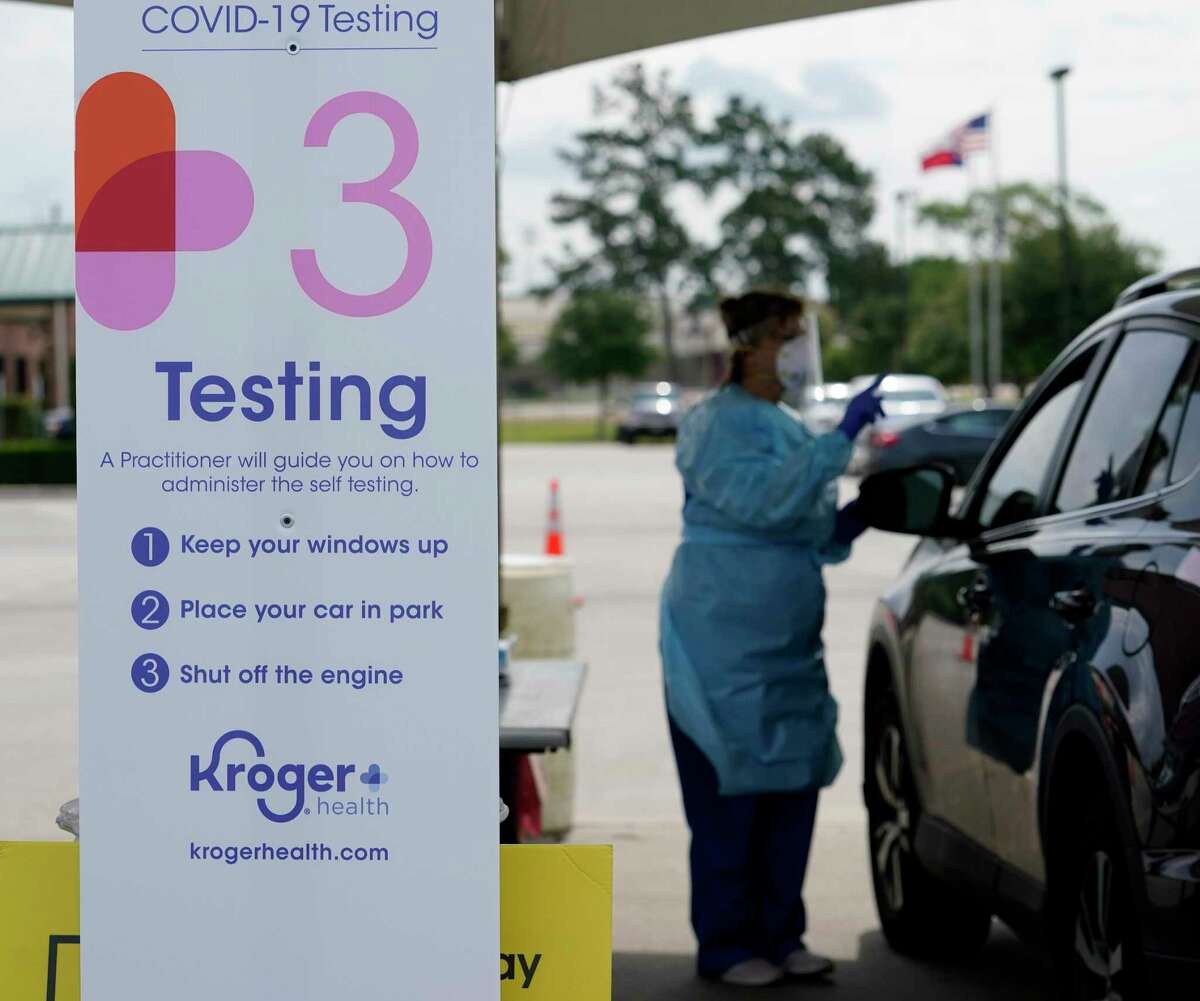 Debbie Veselka, a Kroger pharmacy practice coordinator, gives direction on the self testing procedure at the COVID-19 testing site held at Montgomery County Precinct 2 Commissioner, 19110 Unity Park Drive, Tuesday, May 12, 2020, in Magnolia. This location of the free Kroger Health free COVID-19 drive through testing is open from 9am to 4pm and will continue through Thursday, May 14.