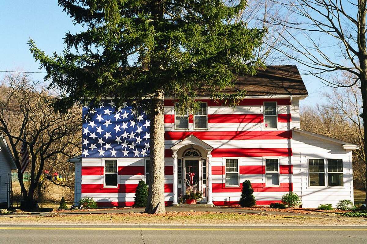 Darien artist Robert Carley has created a series of artwork in tribute to artist Jasper Johns of Sharon. Above, the flag house on Route 7 in Kent, which now is a furniture store.