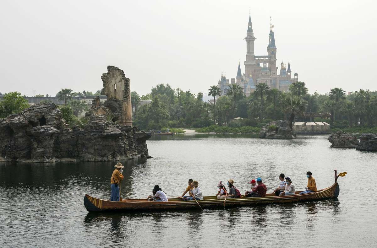 Despite the ubiquity of face masks and some social-distancing measures, photos from the reopening on May 11 looked largely familiar to fans of the parks. Guests canoed, snapped selfies and took a spin on Dumbo the Flying Elephant. They even held parades and took in shows — with noticeably more distance between families than a usually jam-packed Disneyland parade route.