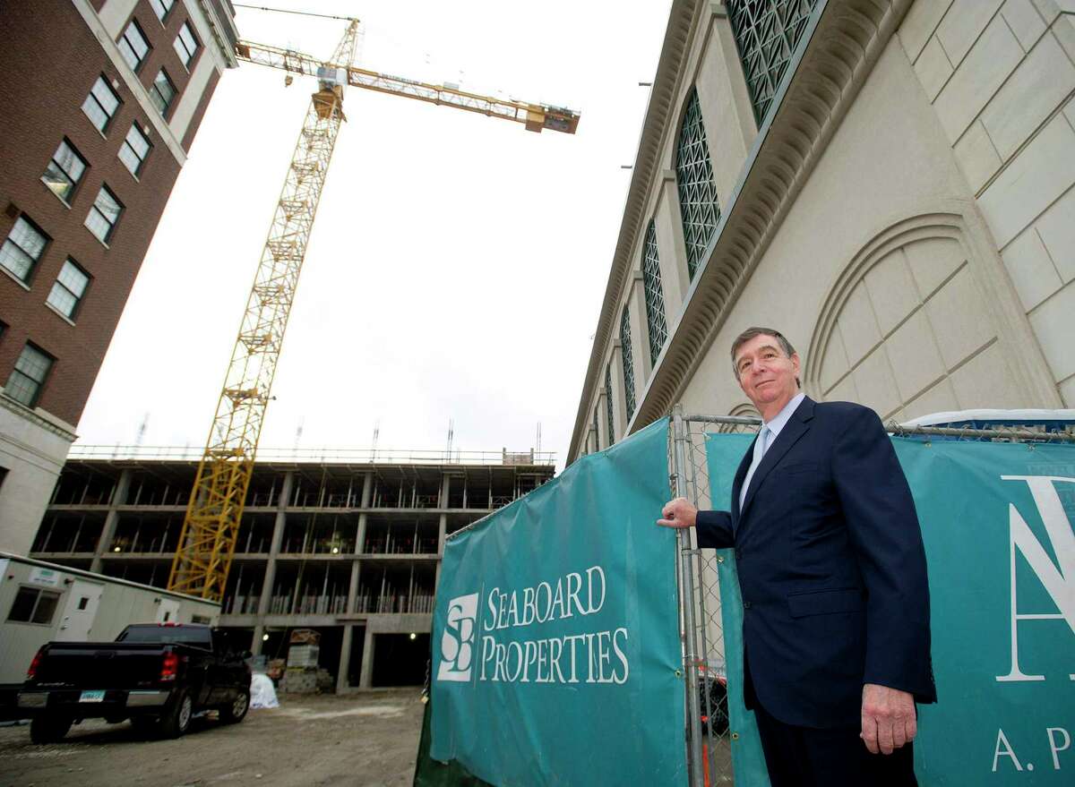 John DiMenna, President of Seaboard Properties, poses for a photo in front of the company's project on Atlantic Street in Stamford, Conn., on Tuesday, November 25, 2014.