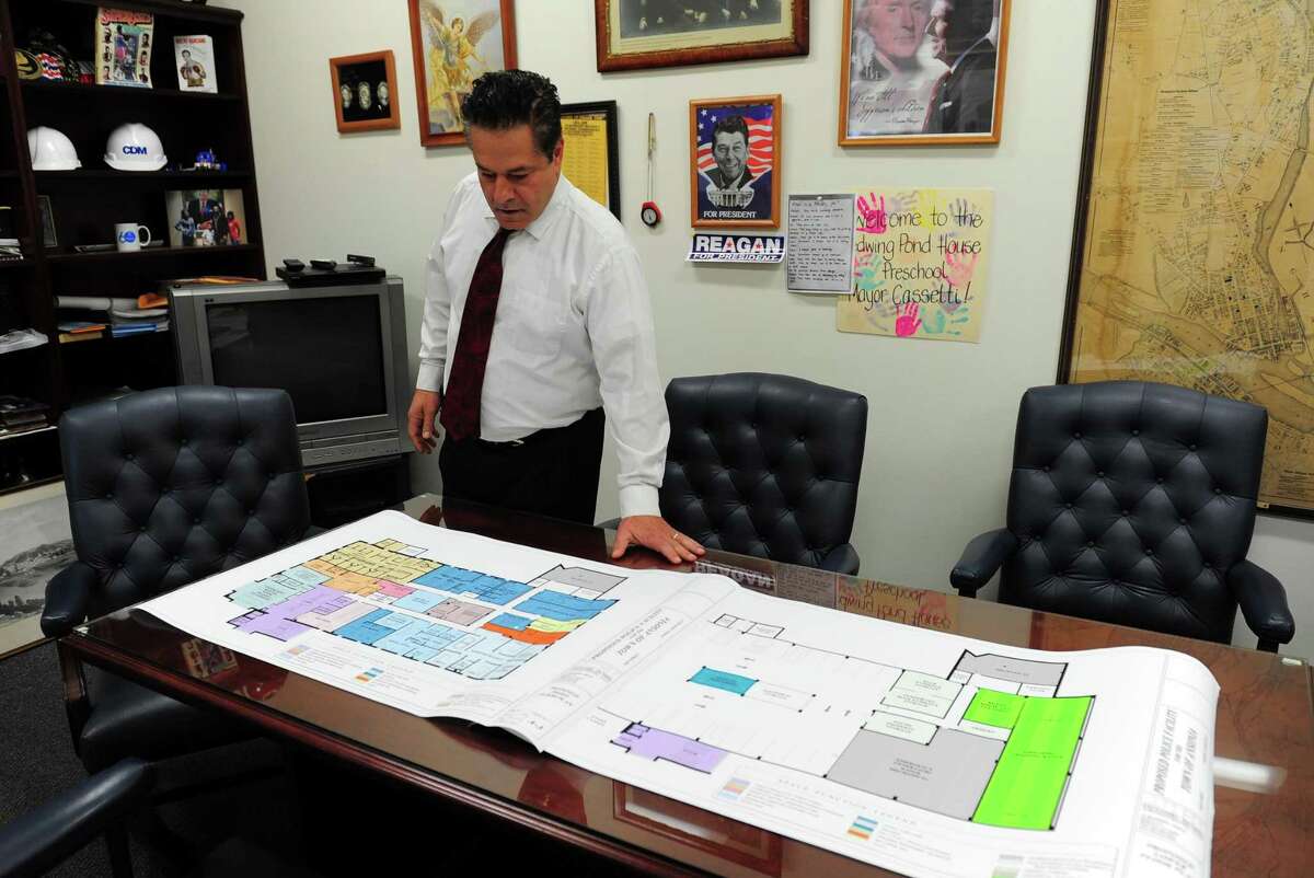 Ansonia Mayor David Cassetti looks over plans for the city's new police station.