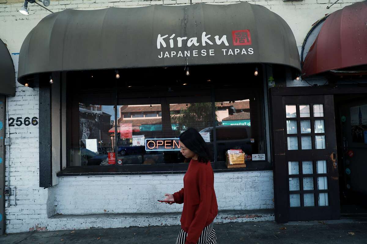 A pedestrian passes by Kiraku, a Japanese restaurant, located at 2566 Telegraph Ave., in Berkeley, Calif., on Wednesday, August 28, 2019. A court ruling in January 2018 allowed California restaurant owners to implement credit card surcharges for the first time in decades -- but very few Bay Area restaurants have actually begun doing so. Kiraku is one of few restaurants in the Bay Area already implementing a surcharge for credit card users.