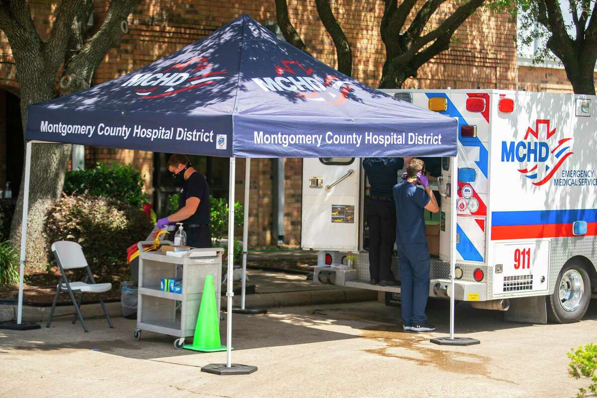 Paramedics with the Montgomery County Hospital District administer tests for COVID-19 outside of an elderly care facility, Thursday, May 14, 2020, at Focused Care at Beechnut in Houston.