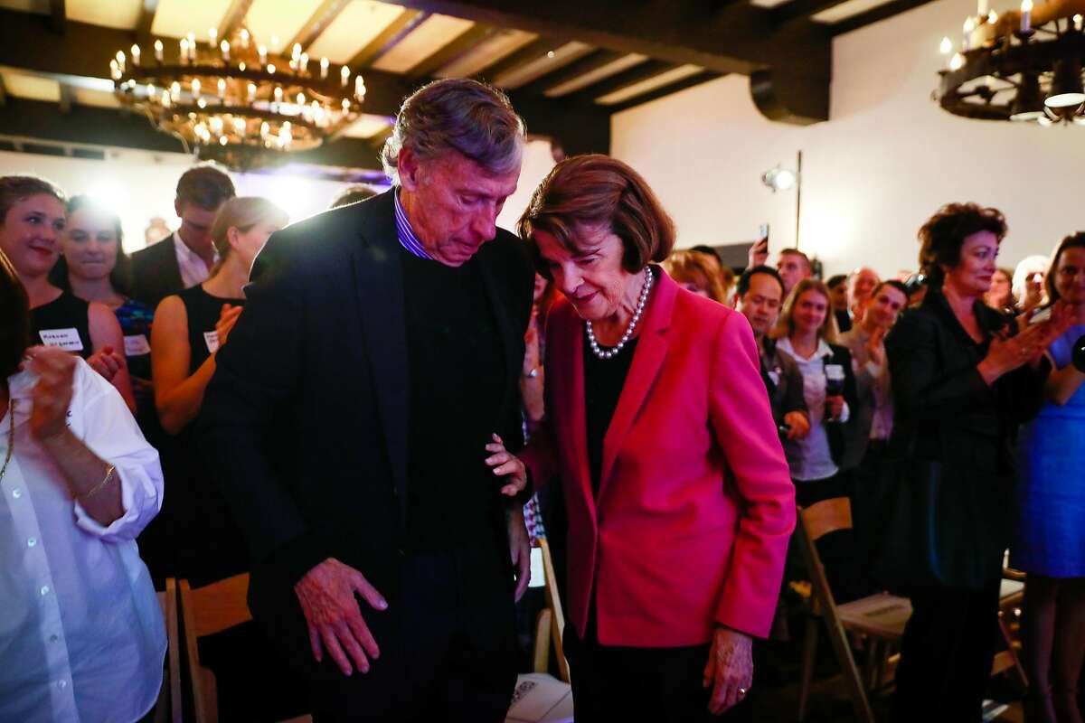 Senator Dianne Feinstein is embraced by her husband Richard Blum (left) after being re-elected for Senator at the Presidio Officers Club in San Francisco, California, on Tuesday, Nov. 6, 2018.