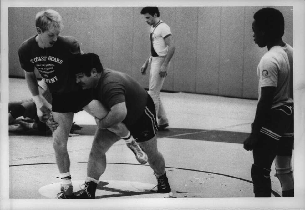 State University of New York, Albany Undated (SUNYA) wrestling coach Joe DeMeo makes move on Dave Averill as Shawn Sheldon watches. December 10, 1984 (Tom LaPoint/Times Union Archive)
