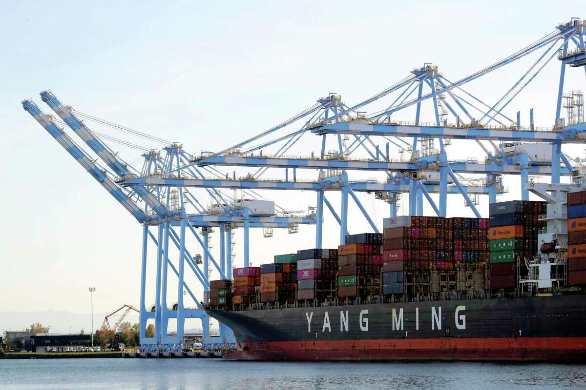 Cargo cranes are used to take containers off of a Yang Ming Marine Transport Corporation boat at the Port of Tacoma in Tacoma, Wash. China has suspended punitive tariffs on more U.S. goods including radar equipment for aviation amid pressure from President Donald Trump to buy more imports as part of a truce in their trade war.