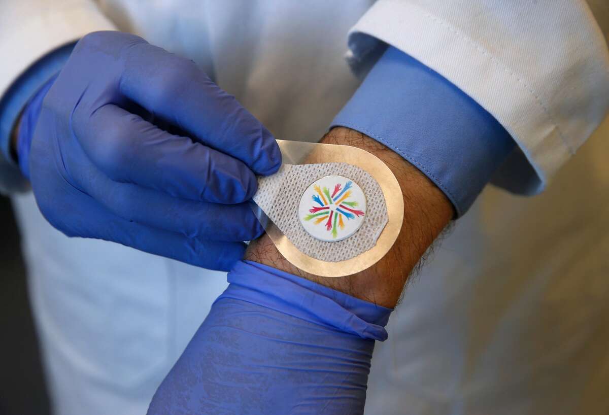 Thomas Ellison tests a vaccine patch under development in a Verndari biotech lab at the UC Davis Medical Center in Sacramento, Calif. on Thursday, May 7, 2020. Verndari is racing to develop a COVID-19 coronavirus vaccine administered through a patch worn on the skin.