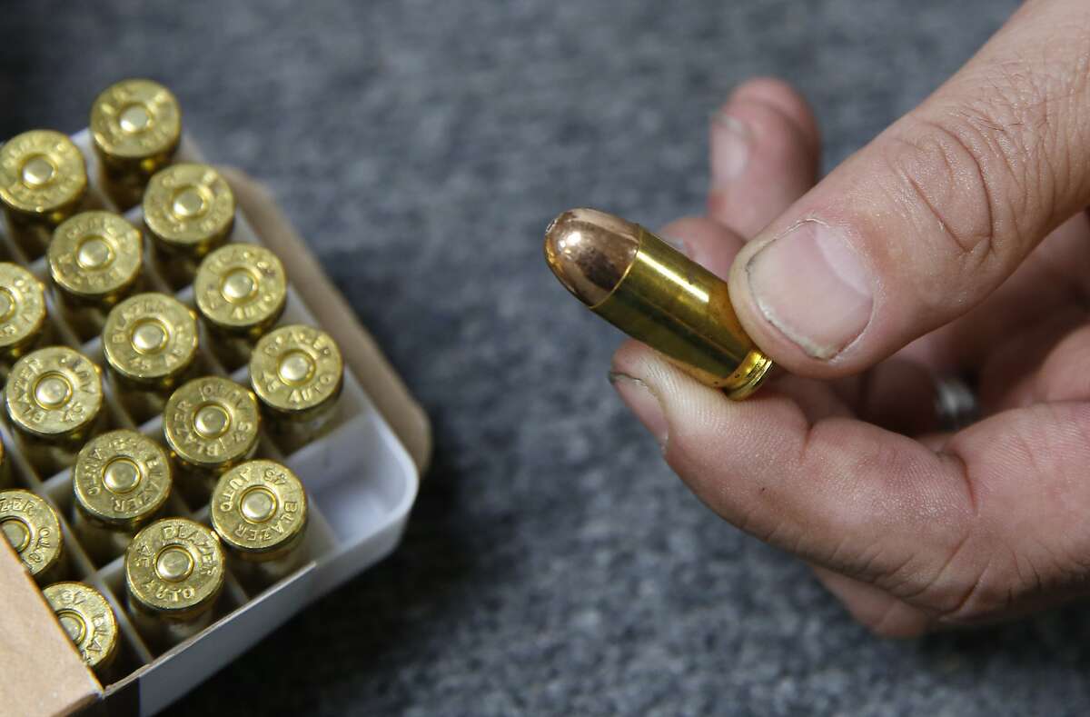FILE - In this June 11, 2019, file photo, Chris Puehse, owner of Foothill Ammo, displays .45-caliber ammunition for sale at his store in Shingle Springs, Calif. An appeals court on Friday, April 24, 2020, has reinstated a California law requiring background checks for people buying ammunition, reversing a federal judge’s decision to stop the checks that he said violate the constitutional right to bear arms. The law, which took effect last July, requires Californians to pass an in-store background check before buying ammunition, which involves running buyers’ names through a California Department of Justice database that tracks legal purchases of guns. (AP Photo/Rich Pedroncelli, File)