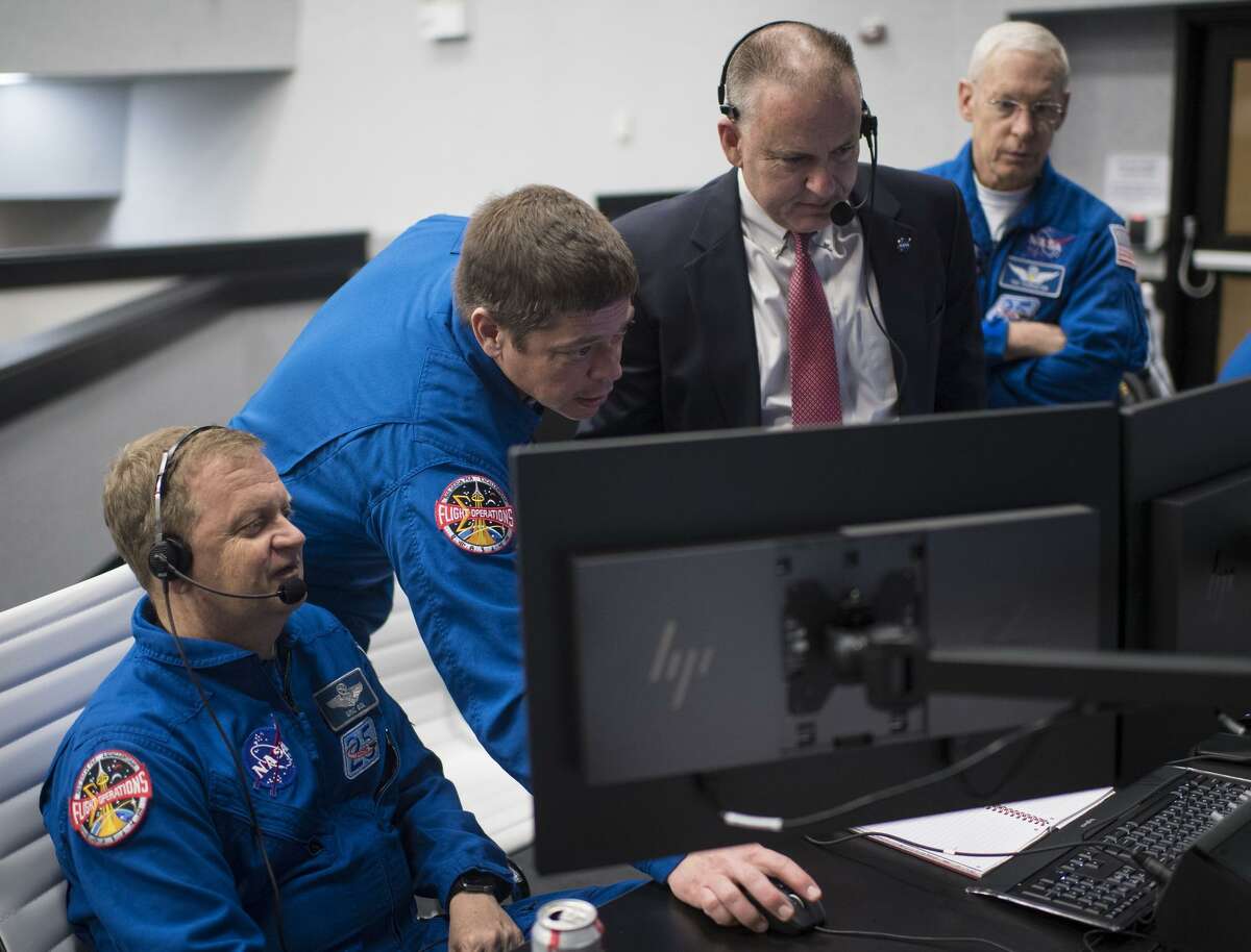NASA astronaut Eric Boe, assistant to the chief of the astronaut office for Commercial Crew, left, NASA astronaut Bob Behnken, Norm Knight, deputy director of flight operations, and Pat Forrester, chief of the astronaut office, monitor the countdown of the launch of a SpaceX Falcon 9 rocket carrying the company's Crew Dragon spacecraft on the Demo-1 mission on March 2, 2019, at the Kennedy Space Center in Florida. The Demo-1 mission was an uncrewed launch to the International Space Station. NASA and SpaceX are now preparing to launch astronauts on May 27.