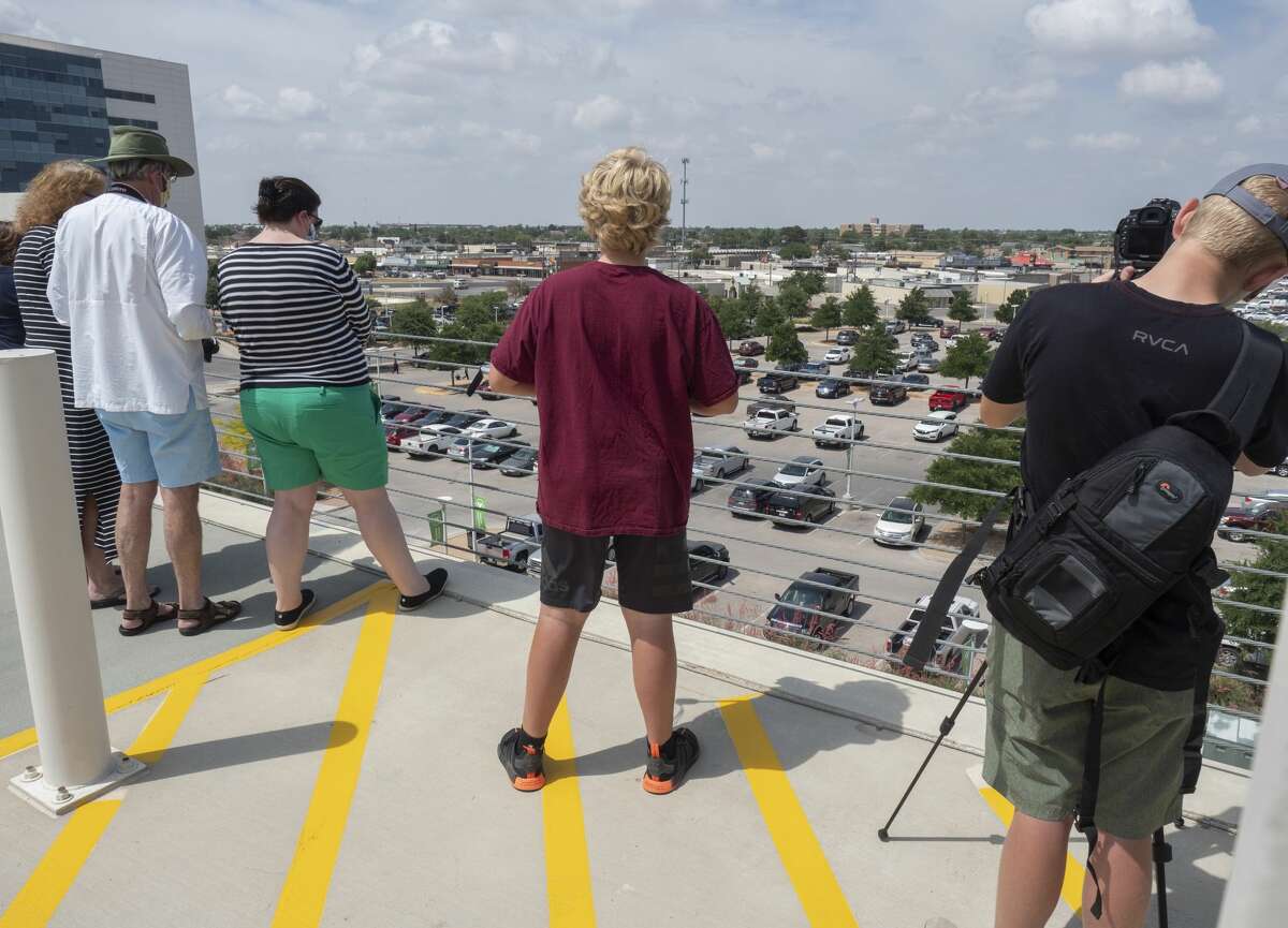 Midlanders wait on the top floor of the Midland Memorial Hospital parking garage 05/15/2020 to watch a B1B Lancer out of Dyess Air Force Base flyover the hospital and Midland as a salute to medical professionals, first responders and others. Tim Fischer/Reporter-Telegram