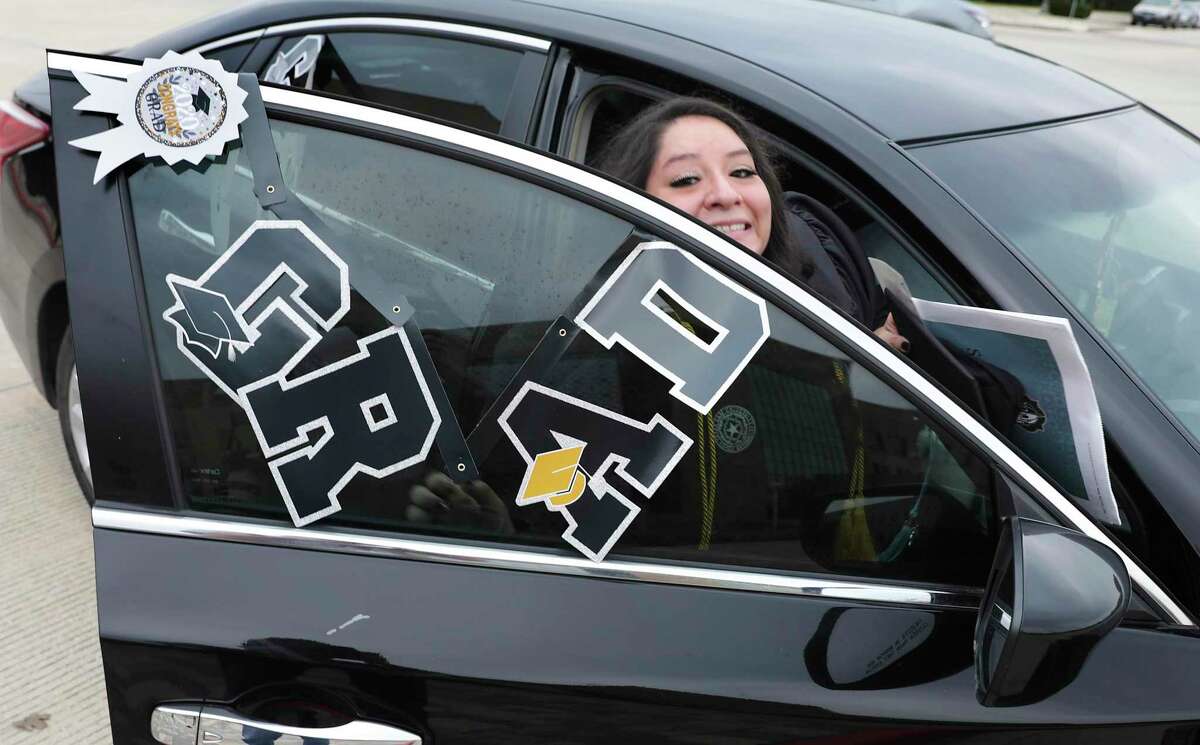 Lyzette Garza smiles at friends as she gets in her car following the curbside graduation ceremony Friday at Texas A&M University San Antonio.