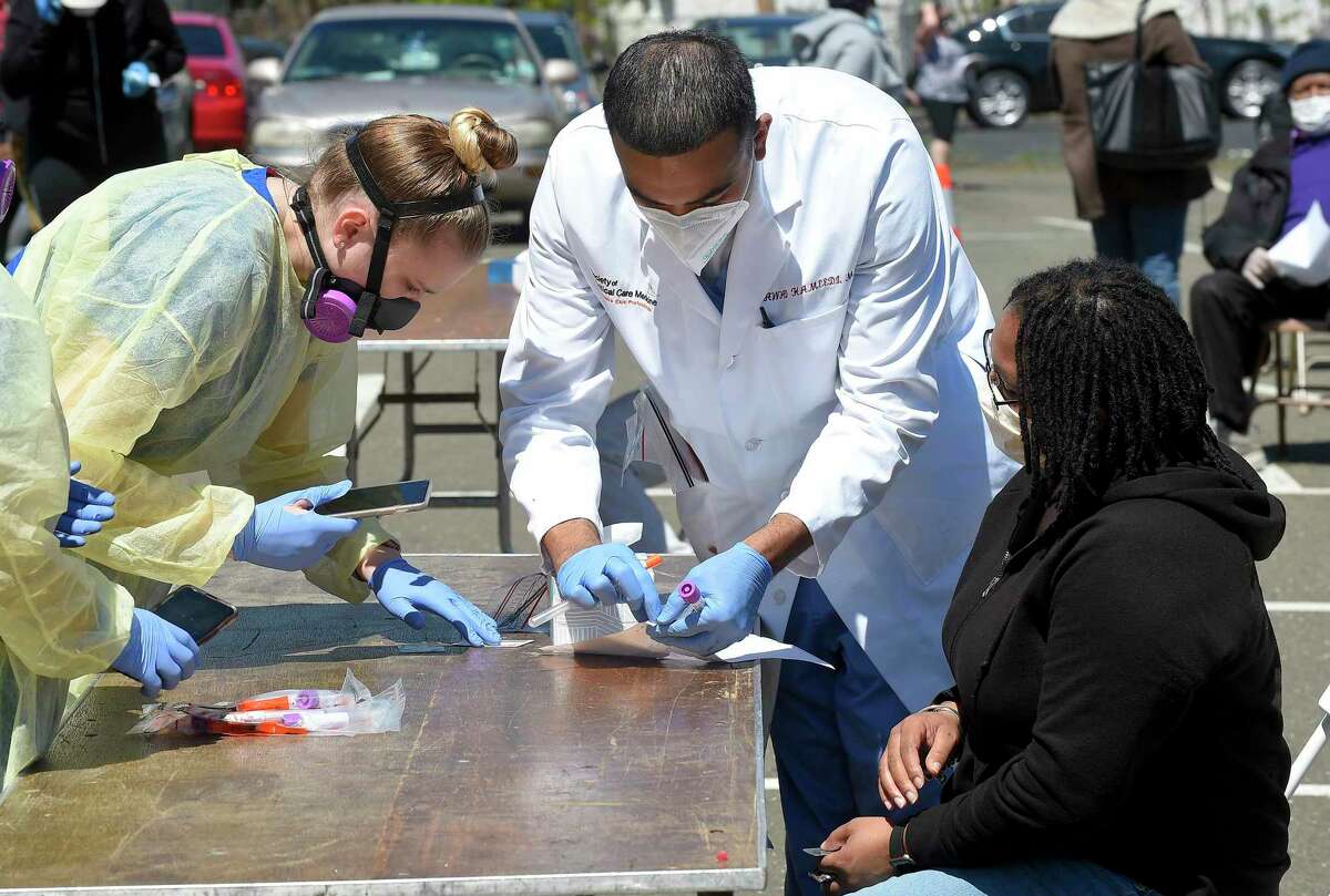 Dr. Fawad Hameedi of DOCS Urgent Care Stamford administers a COVID-19 nasal swab test on Lakeisha Thompson, 34, of Stamford at a walk up testing site for the Coronavirus at AME Bethel Church in Stamford, Connecticut on May 2, 2020. Over 200 tests were perform by medical professinals for residents of Stamford's Westside.