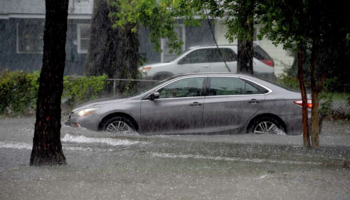 Vehicles make their way through a section of Phelan Boulevard, which quickly flooded, stalling out smaller vehicles caught amid the quickly rising water following heavy storms late Thursday afternoon. Photo taken Thursday, May 14, 2020 Kim Brent/The Enterprise