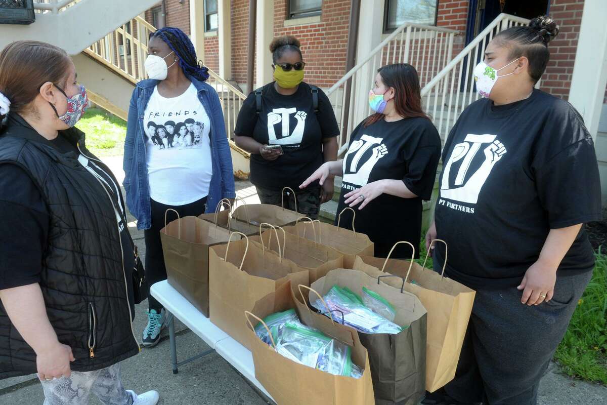 Members of PT Partners, a group of resident volunteers at the P.T. Barnum Apartments, meet after receiving hundreds of hand-sewn protective masks in Bridgeport, Conn. May 15, 2020. The mask are sewn by other volunteers at nearby Burroughs Community Center, and PT Partners will distribute them to every resident of the public housing complex.