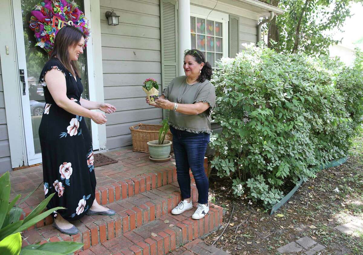 Debbie Alcoser, right, and Alisha Coyle belong to a Facebook group that helps folks give and take free household items. The group has grown in popularity as a way of connecting with neighbors during the coronavirus pandemic.