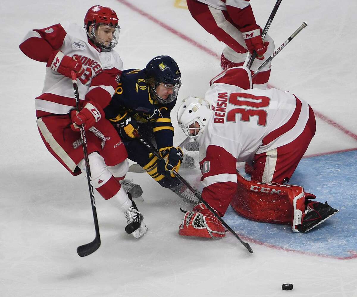Sacred Heart goalie Josh Benson make a save on Quinnipiac’s Nick Jermain in the second period of the championship game of the Connecticut Ice tournament at the Webster Bank Arena in Bridgeport in January.