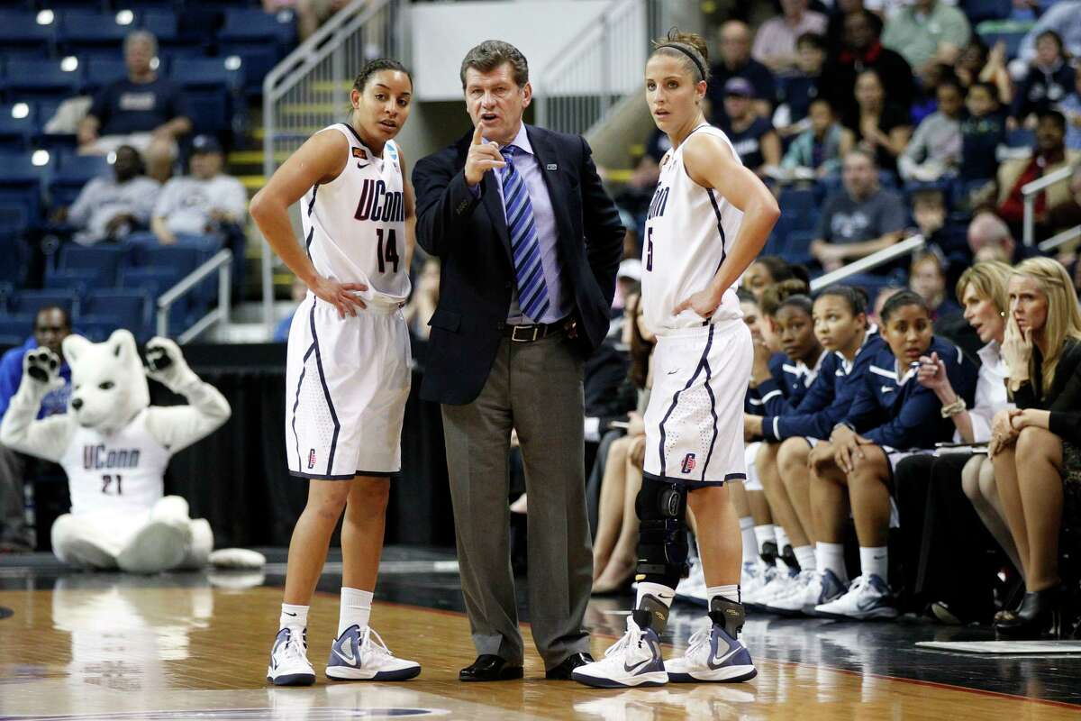 Mar 19, 2012; Bridgeport, CT, USA; Connecticut Huskies head coach Geno Auriemma talks with guard Bria Hartley (14) and guard Caroline Doty (5) during a break in the action against the Kansas State Wildcats during the first half in the second round of the 2012 NCAA women's basketball tournament at Arena at Harbor Yard. UConn defeated the Kansas State Wildcats 72-26. Mandatory Credit: David Butler II-US PRESSWIRE