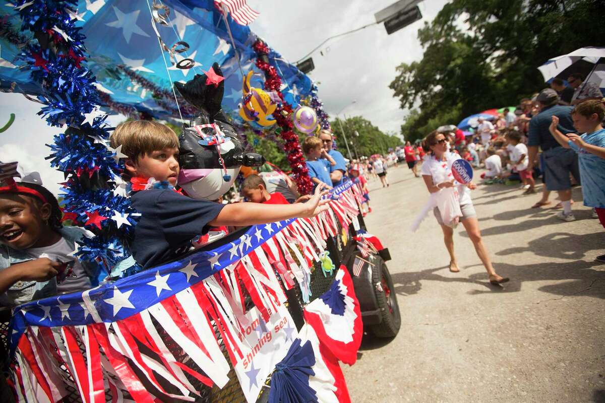 Kids from Good Shepherd Episcopal School throw candy to the crowd during the Kingwood 4th of July Parade on July 4, 2015, in Kingwood.