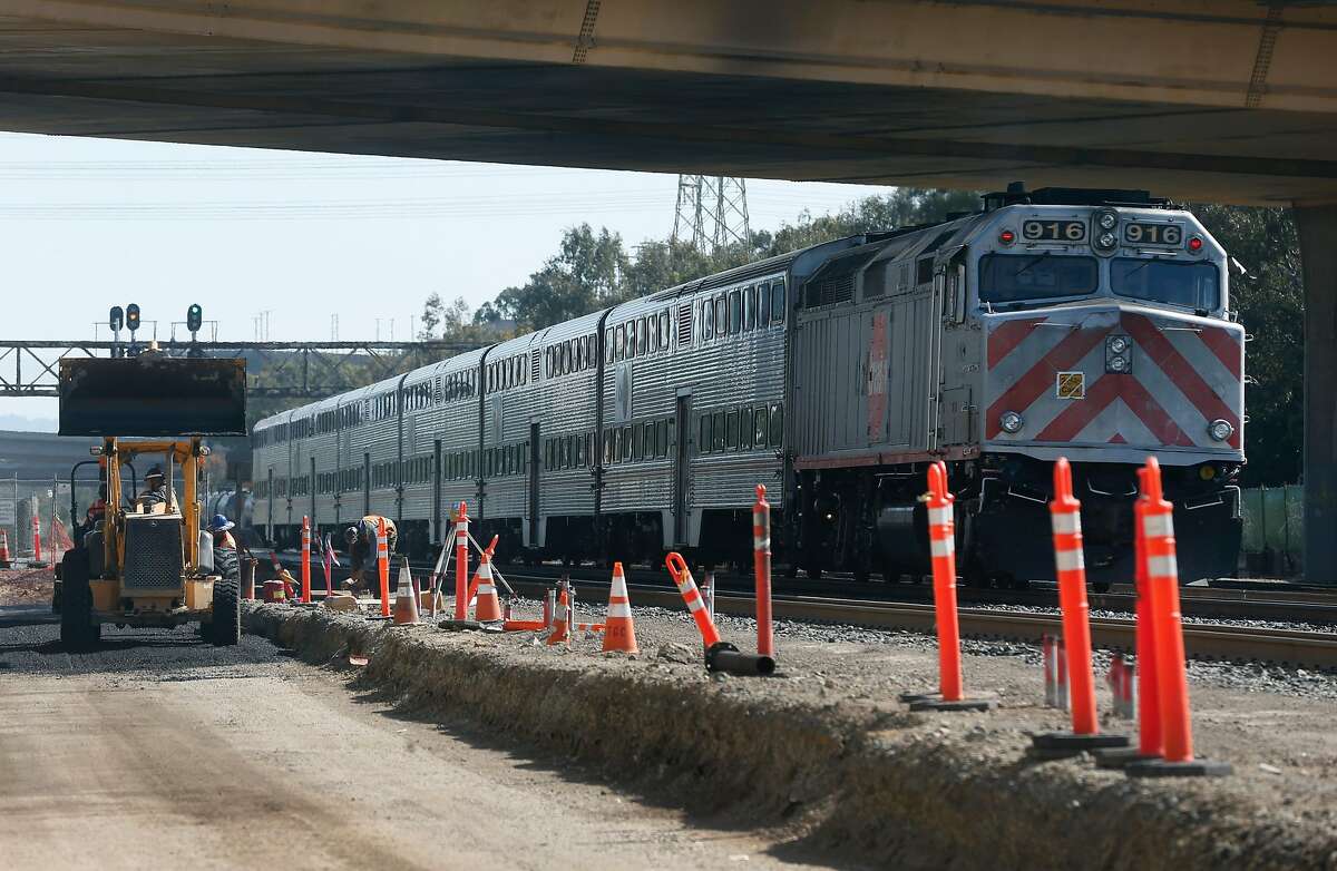 A northbound train makes a scheduled stop where the new Caltrain station is under construction in South San Francisco on Wednesday, May 6, 2020.