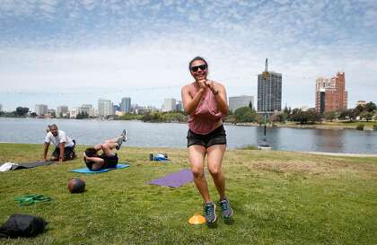 Mary Massella works out during a fitness session at Lake Merritt.