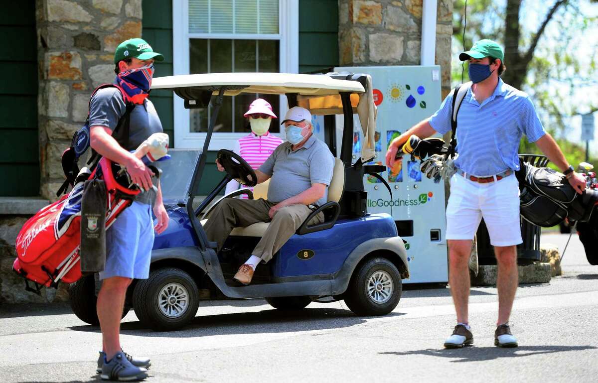 Golfers use social distancing as they wait to tee off at Fairchild Wheeler Golf Course in Bridgeport, Conn., on Saturday May 16, 2020. The course opened back up on Friday.