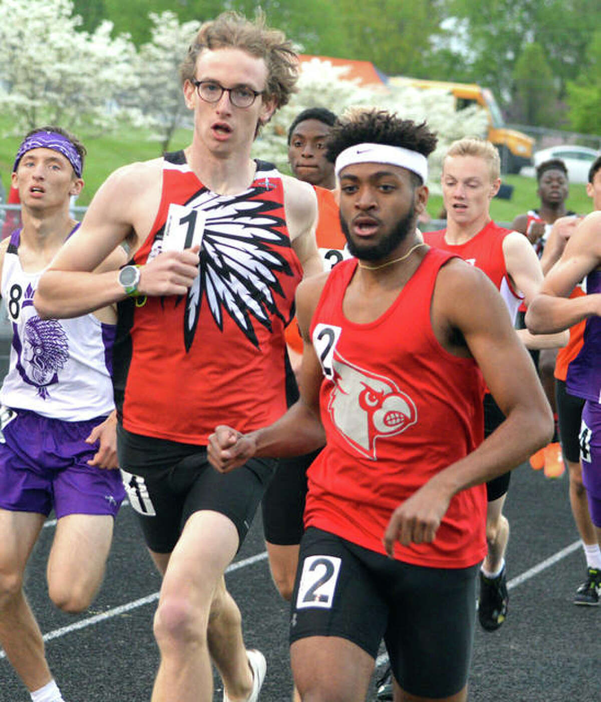 Granite City’s Andrew O’Keefe (left) and Alton’s Cassius Havis run side-by-side in the 800 meters at the 2019 Madison County Large-Schools Track Meet at Troy.