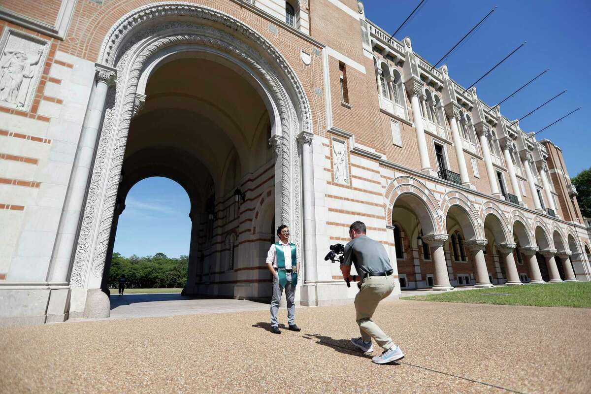 Brandon Martin, right, the manager of videography at Rice University, shoots video footage of Shree Kale, who will be graduating from the School of Architecture, on the Rice campus in Houston, Friday, May 1, 2020. Martin is helping film and orchestrate the private Houston university's virtual commencement, which will be held on May 16. Rice officials are planning to stream a pre-recorded feature-length-style video that will include college officials naming each graduate, student profiles, essays, comments from President David Leebron and faculty and staff. Kale, was chosen to be video taped because of an essay that he wrote.