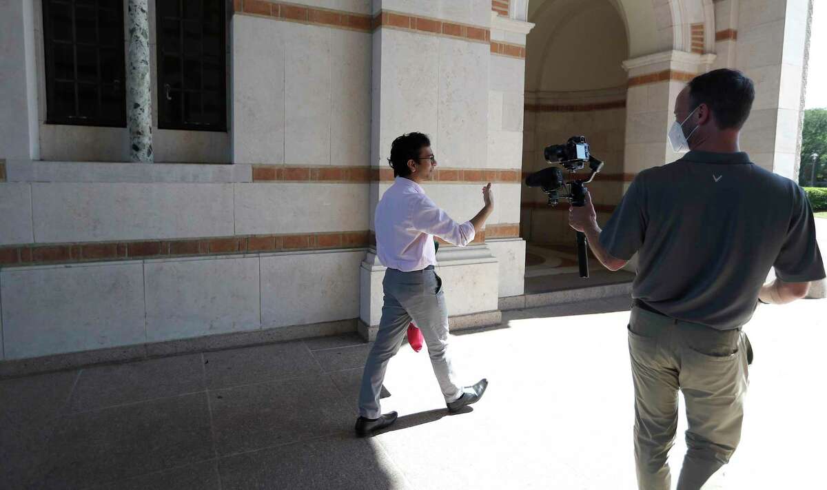 Brandon Martin, right, the manager of videography at Rice University, shoots video footage of Shree Kale, who will be graduating from the School of Architecture, on the Rice campus in Houston, Friday, May 1, 2020. Martin is helping film and orchestrate the private Houston university's virtual commencement, which will be held on May 16. Rice officials are planning to stream a pre-recorded feature-length-style video that will include college officials naming each graduate, student profiles, essays, comments from President David Leebron and faculty and staff. Kale, was chosen to be video taped because of an essay that he wrote.