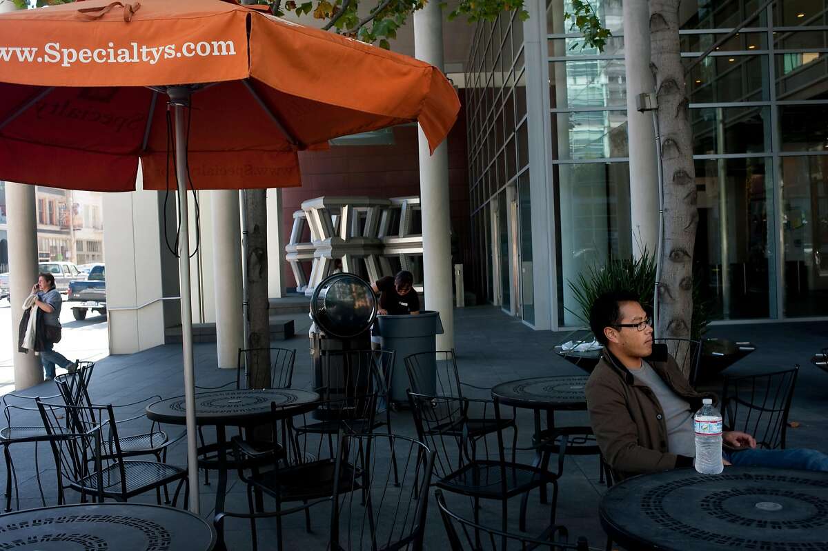 Gally Galgana (right) sits on the patio of Specialty's CafŽ & Bakery on Friday, October 7, 2011 in San Francisco, Calif. The 2-month-old cafe fills a retail space in the Foundry Square building that had previously been empty for eight years.