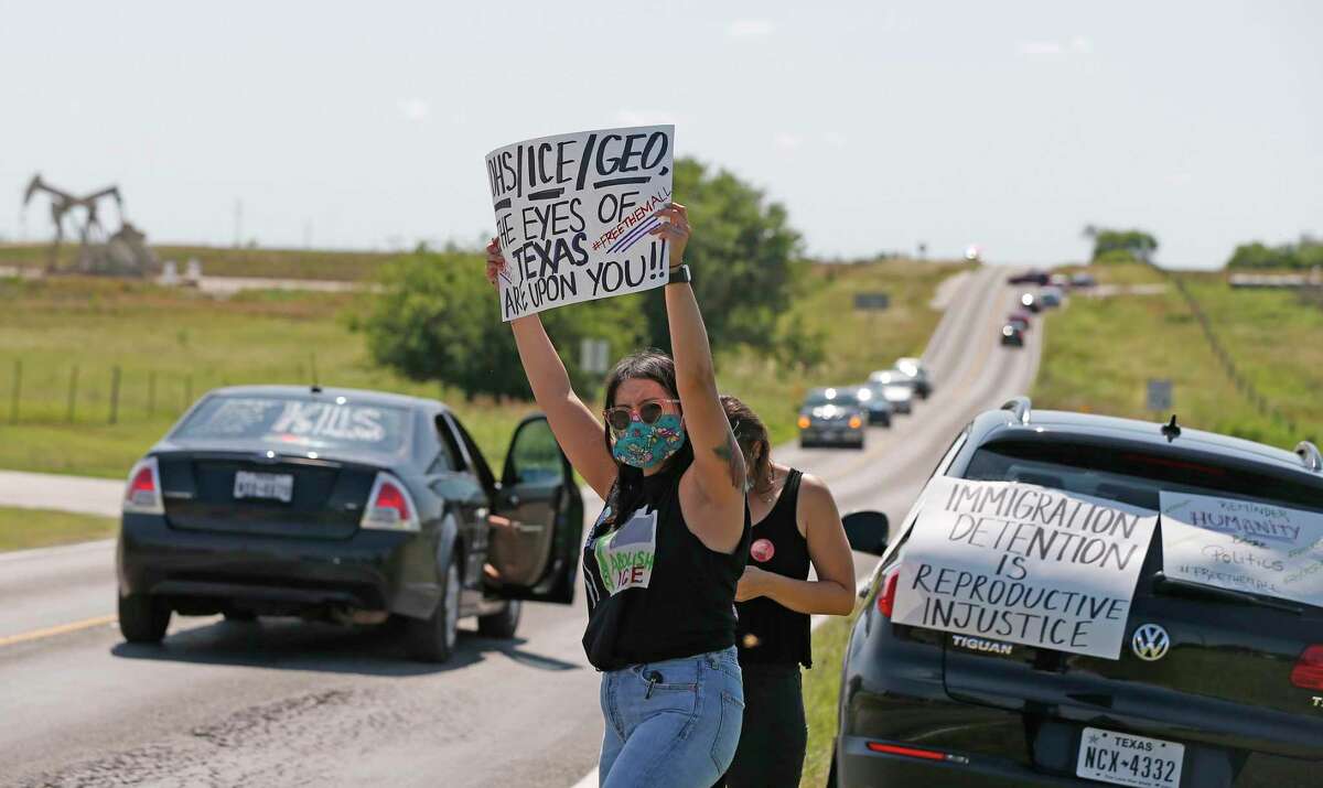 Laura Molinar protest in front of the Karnes County Residential Center as other advocacy group car protest drove past the center at 409 FM1144, Karnes City, Texas, 78118. Advocacy groups are protesting family detention amid the pandemic, as coronavirus spreads rapidly through detention facilities across the country on Saturday, May 16, 2020.