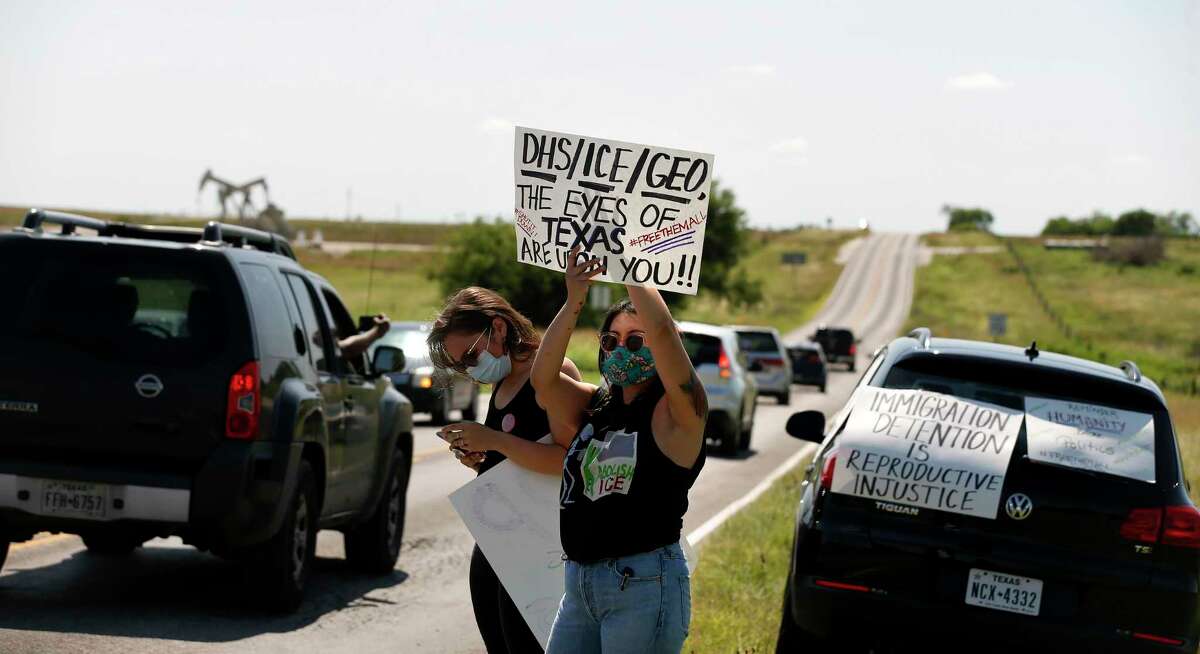 Laura Molinar protest in front of the Karnes County Residential Center as other advocacy group car protest drove past the center at 409 FM1144, Karnes City, Texas, 78118. Advocacy groups are protesting family detention amid the pandemic, as coronavirus spreads rapidly through detention facilities across the country on Saturday, May 16, 2020.