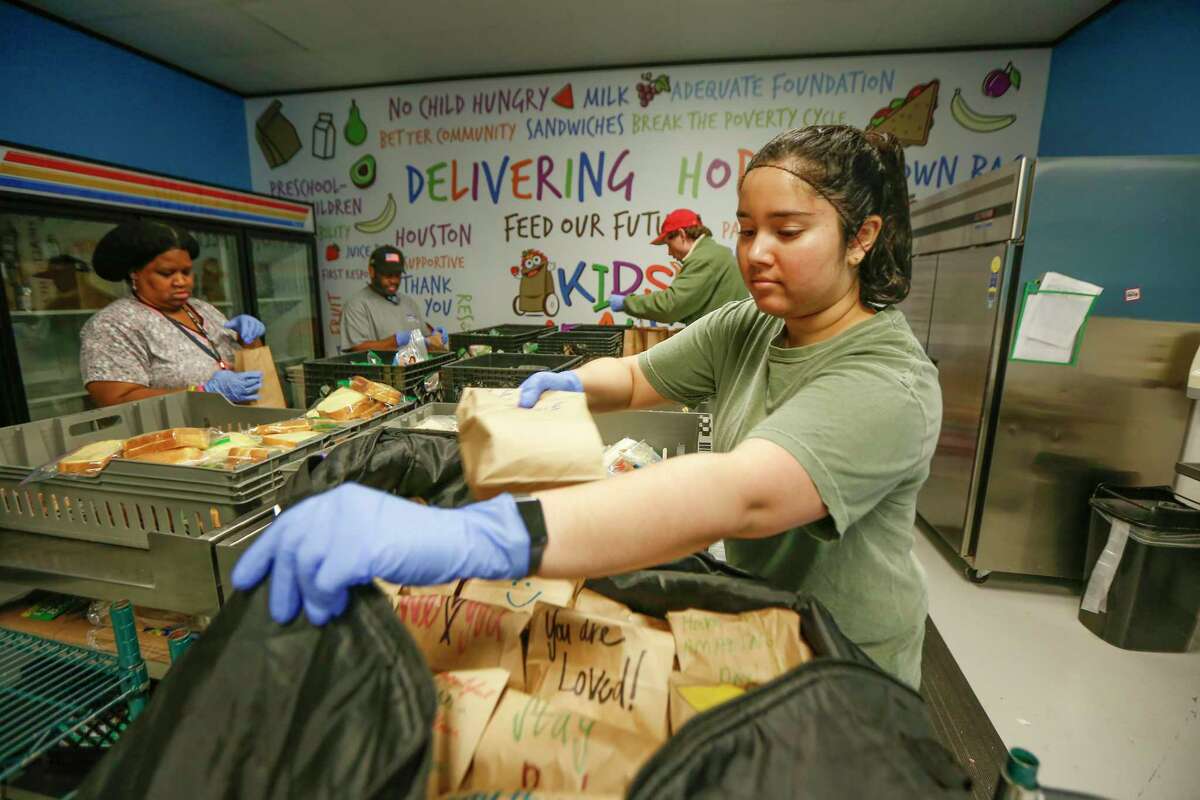 Joanne Jacob helps pack lunches for children at Kids Meals Inc, Tuesday, April 7, 2020, in Houston. Kids Meals Inc, a non-profit that delivers meals to pre-school age children who live in underserved communities.