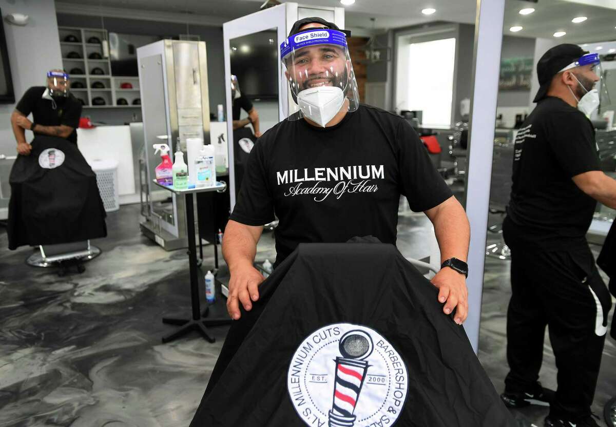 Owner Alex Martinez has stations set up over twelve feet apart in preparation for re-opening his Al's Millennium Cuts Barbershop and Salon in Bridgeport, Conn. on Monday, May 18, 2020. Governor Lamont announced Monday a postponement of salon re-openings until June. Martinez said he was fully booked for the previously planned Wednesday opening.