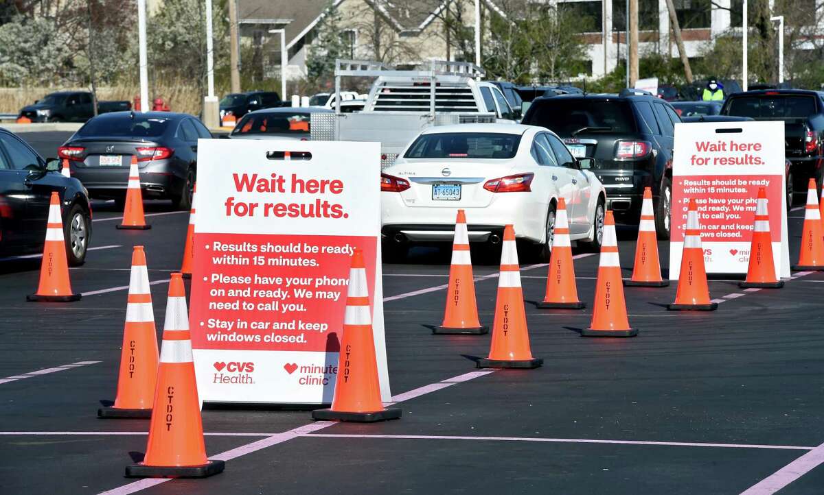 Cars wait in the parking lot of Jordan's Furniture for results after a COVID-19 test by health care providers from CVS MinuteClinics in the parking lot of the former Gateway Community College in New Haven on April 17, 2020 in a partnership between CVS and Abbott Laboratories.
