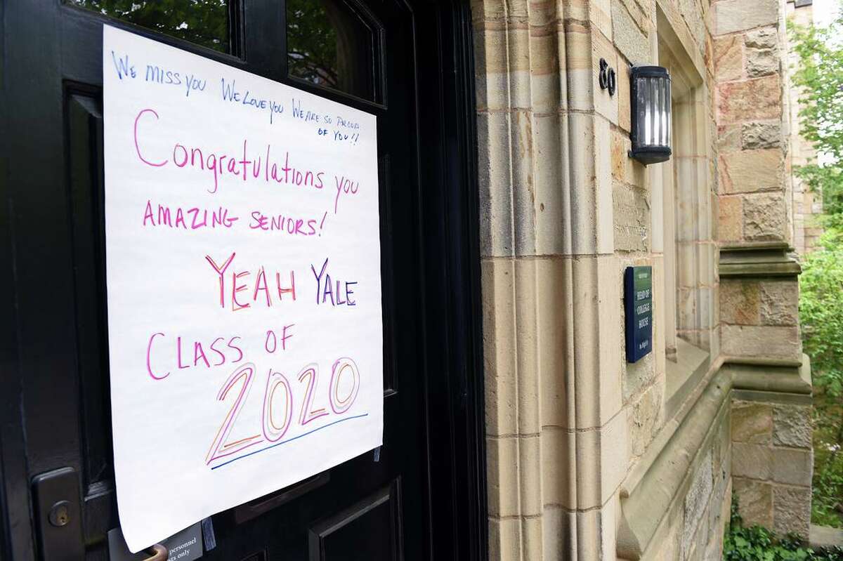 A sign congratulating Yale University graduates is displayed on a door at Branford College in New Haven on what would have been their commencement on May 18, 2020. Yale University President Peter Salovey delivered an address and conferred degrees via YouTube.